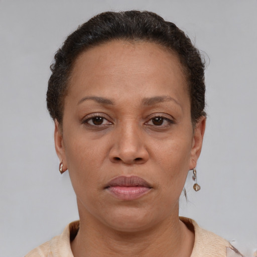 Neutral latino adult female with short  brown hair and brown eyes