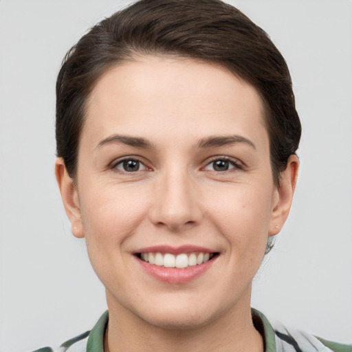 Joyful white young-adult female with short  brown hair and brown eyes