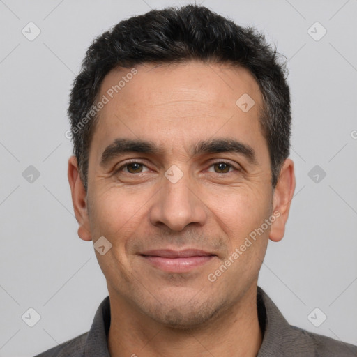 Joyful white adult male with short  black hair and brown eyes