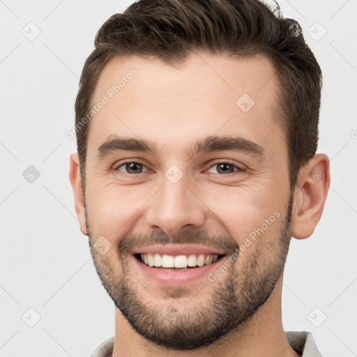 Joyful white young-adult male with short  brown hair and brown eyes