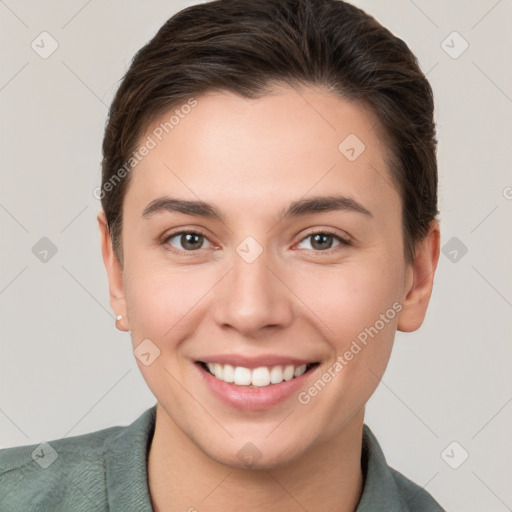 Joyful white young-adult female with short  brown hair and brown eyes