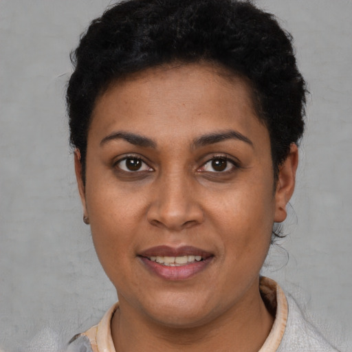 Joyful latino young-adult female with short  brown hair and brown eyes