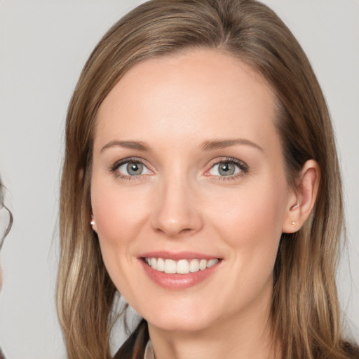 Joyful white young-adult female with long  brown hair and brown eyes