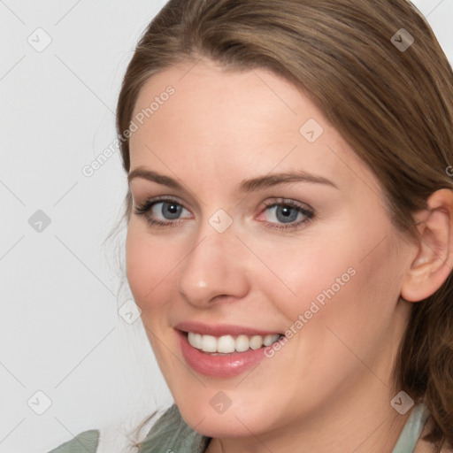 Joyful white young-adult female with long  brown hair and green eyes