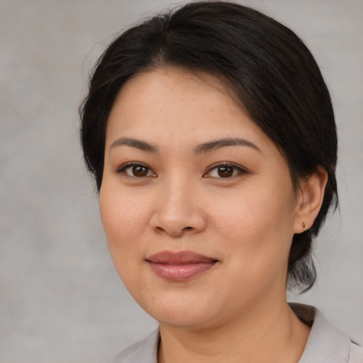 Joyful asian young-adult female with medium  brown hair and brown eyes