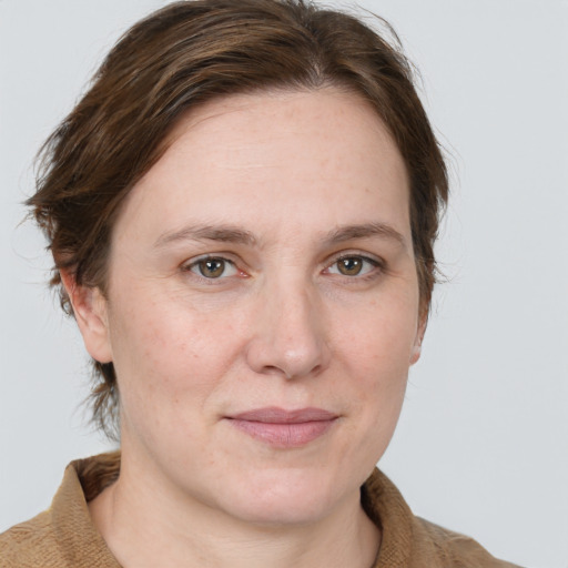 Joyful white adult female with medium  brown hair and blue eyes