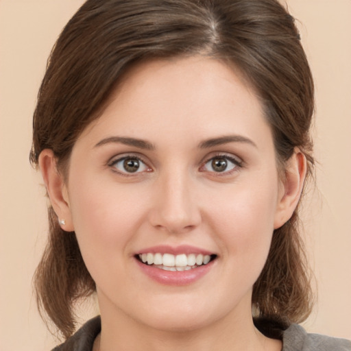 Joyful white young-adult female with medium  brown hair and brown eyes