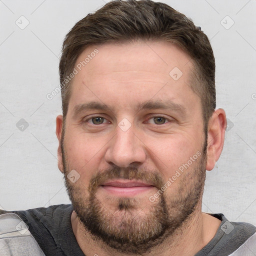 Joyful white adult male with short  brown hair and grey eyes