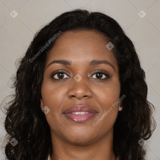 Joyful black young-adult female with long  brown hair and brown eyes