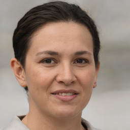 Joyful white adult female with short  brown hair and brown eyes