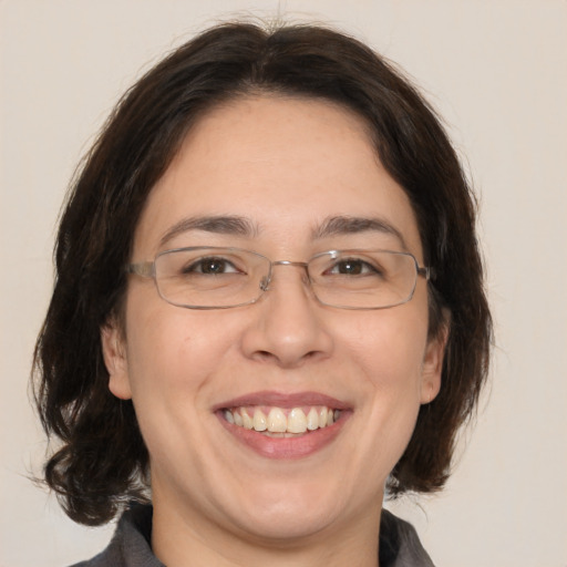 Joyful white adult female with medium  brown hair and brown eyes