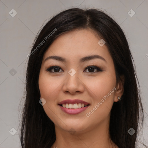 Joyful asian young-adult female with long  brown hair and brown eyes