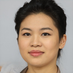 Joyful asian young-adult female with short  brown hair and brown eyes