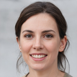 Joyful white young-adult female with medium  brown hair and grey eyes