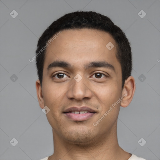 Joyful latino young-adult male with short  black hair and brown eyes