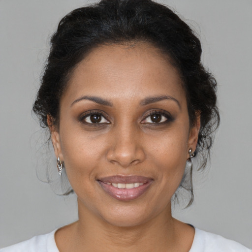 Joyful black young-adult female with medium  brown hair and brown eyes