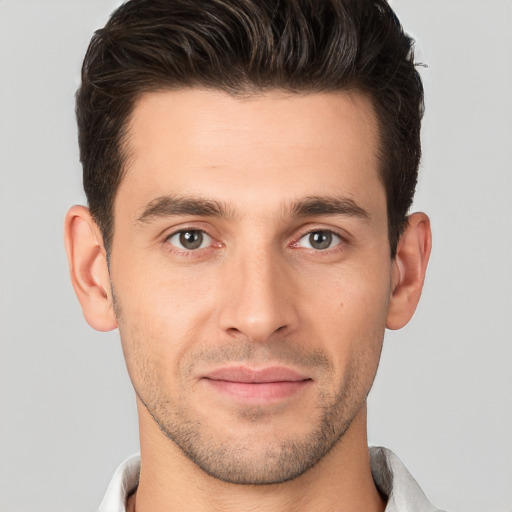 Joyful white young-adult male with short  brown hair and brown eyes