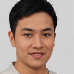 Joyful asian young-adult male with short  brown hair and brown eyes