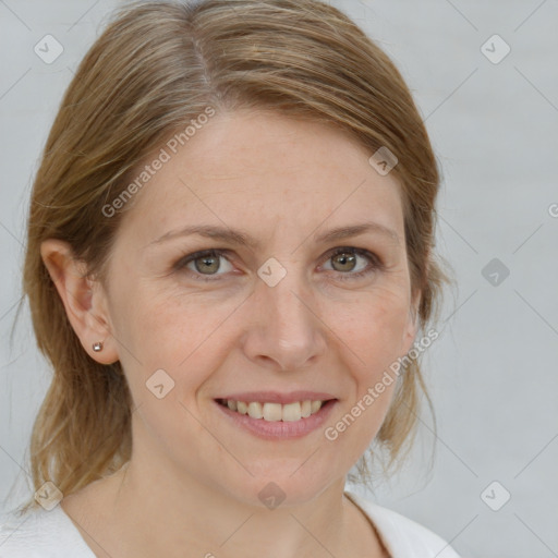 Joyful white adult female with medium  brown hair and grey eyes