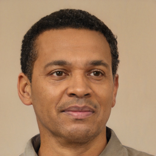 Joyful latino adult male with short  brown hair and brown eyes