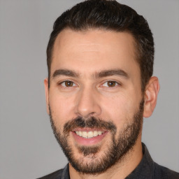 Joyful white adult male with short  brown hair and brown eyes