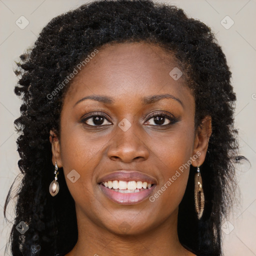 Joyful black young-adult female with long  brown hair and brown eyes