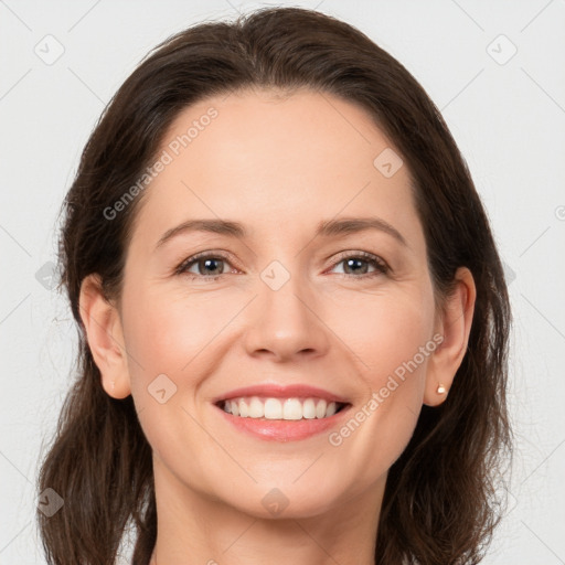 Joyful white young-adult female with long  brown hair and grey eyes