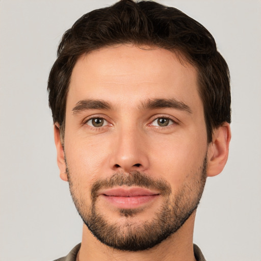 Joyful white young-adult male with short  brown hair and brown eyes