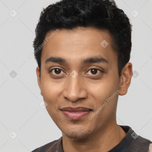 Joyful latino young-adult male with short  black hair and brown eyes