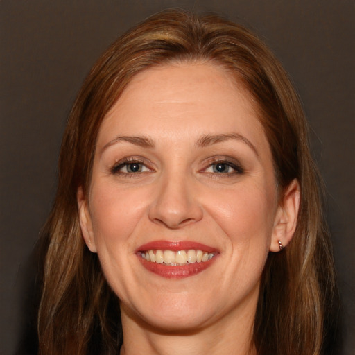 Joyful white adult female with long  brown hair and brown eyes