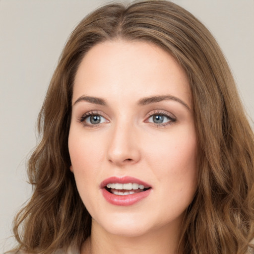 Joyful white young-adult female with long  brown hair and green eyes