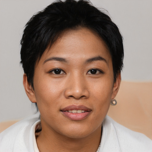Joyful asian young-adult female with short  brown hair and brown eyes