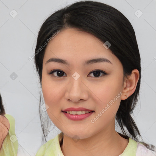 Joyful asian young-adult female with medium  black hair and brown eyes