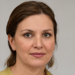 Joyful white adult female with medium  brown hair and brown eyes