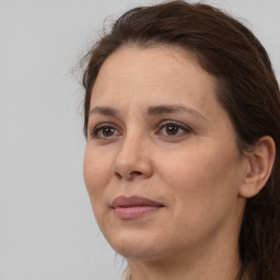 Joyful white adult female with medium  brown hair and brown eyes