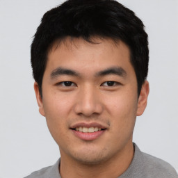 Joyful asian young-adult male with short  black hair and brown eyes