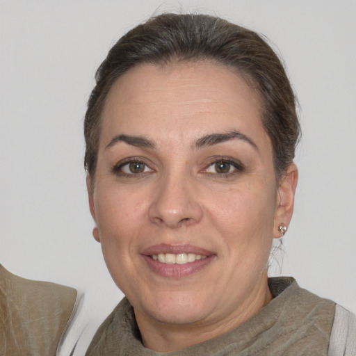Joyful white adult female with short  brown hair and brown eyes