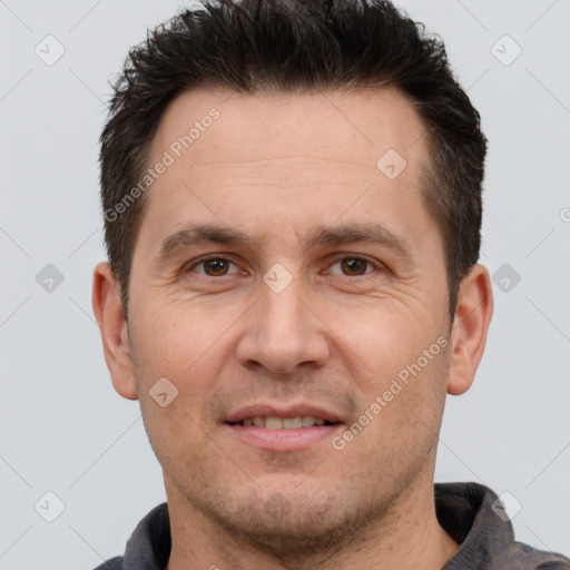 Joyful white adult male with short  brown hair and brown eyes