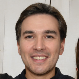 Joyful white young-adult male with short  brown hair and brown eyes