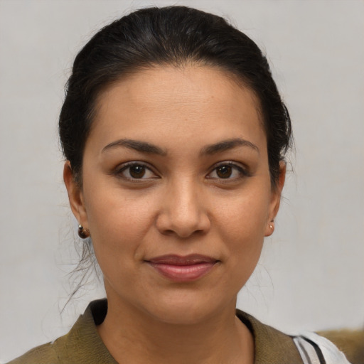 Joyful latino young-adult female with medium  brown hair and brown eyes