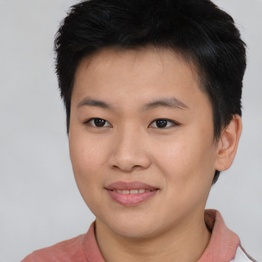 Joyful asian young-adult male with short  brown hair and brown eyes