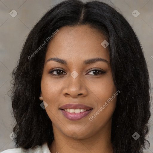 Joyful black young-adult female with long  brown hair and brown eyes