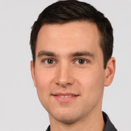 Joyful white young-adult male with short  brown hair and brown eyes