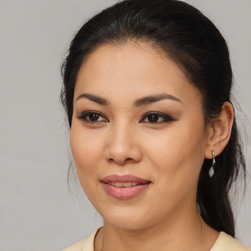 Joyful latino young-adult female with medium  brown hair and brown eyes