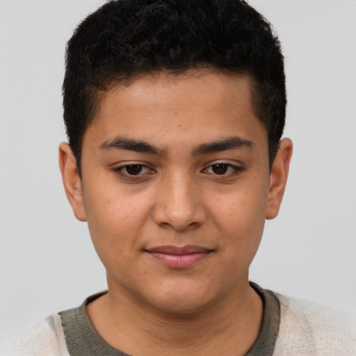 Joyful latino young-adult male with short  brown hair and brown eyes
