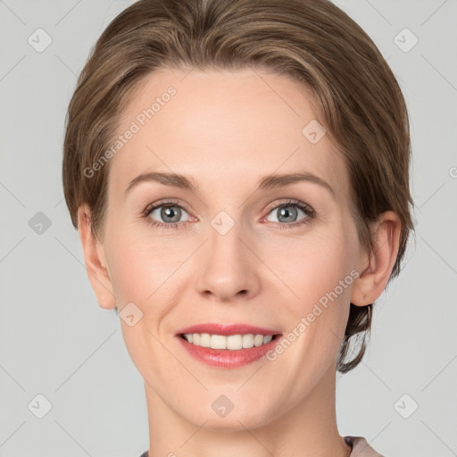 Joyful white young-adult female with short  brown hair and grey eyes