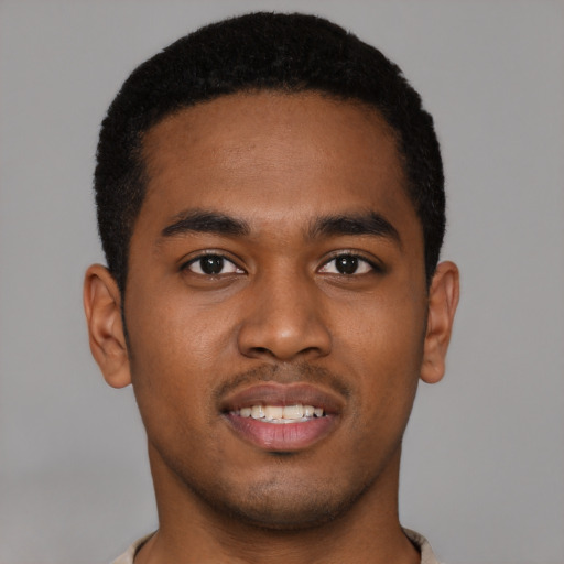 Joyful black young-adult male with short  brown hair and brown eyes