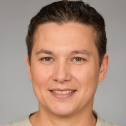 Joyful white adult male with short  brown hair and brown eyes