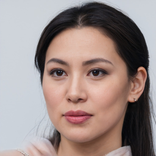 Joyful asian young-adult female with long  brown hair and brown eyes