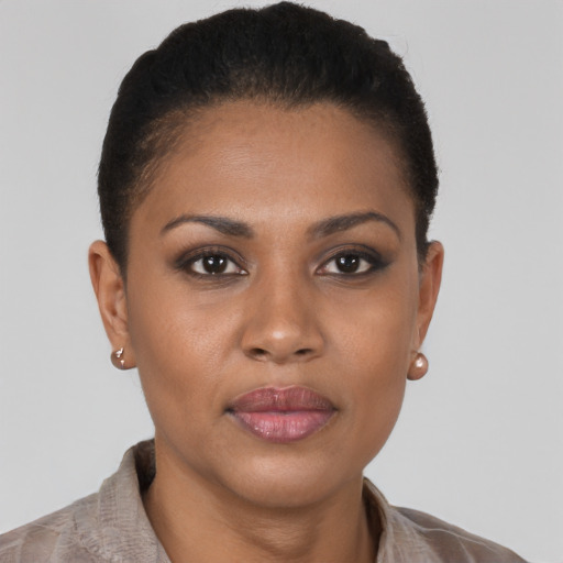 Joyful black young-adult female with short  brown hair and brown eyes